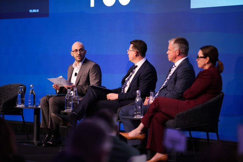 Anthony Saliba moderating a panel discussion on stage at an FSC conference